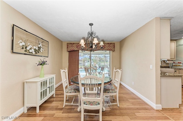 dining space with an inviting chandelier and light wood-type flooring