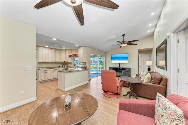 living room with vaulted ceiling, light hardwood / wood-style floors, and ceiling fan