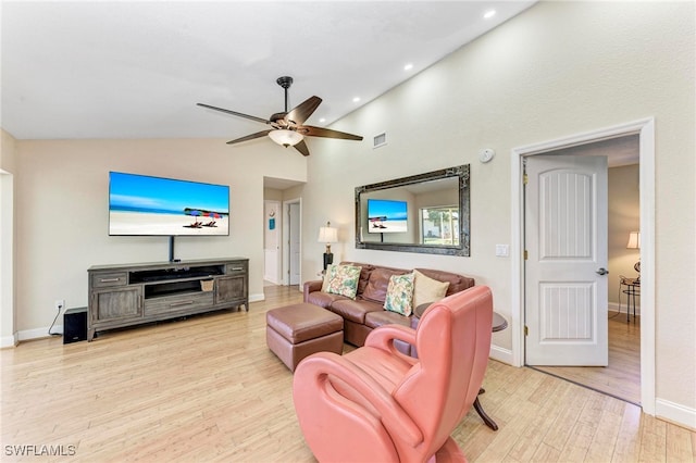 living room with ceiling fan, high vaulted ceiling, and light wood-type flooring