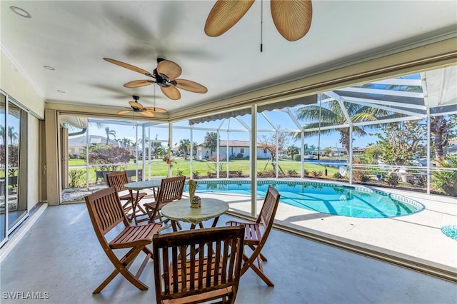 view of swimming pool featuring a lanai, a patio, and ceiling fan