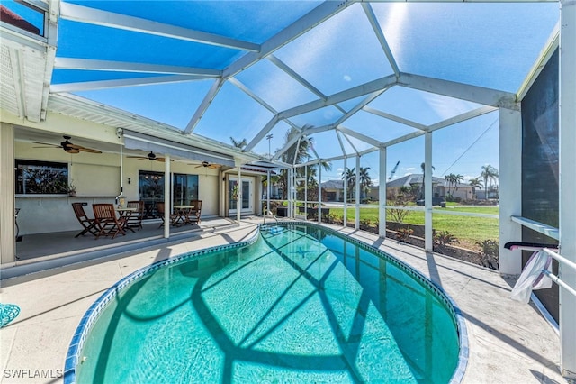 view of swimming pool featuring a patio, a lanai, and ceiling fan