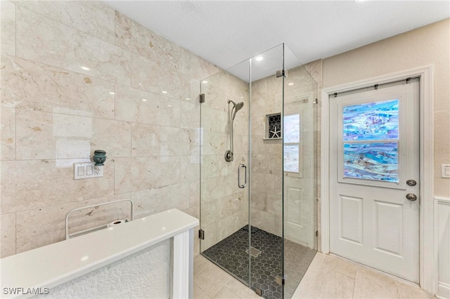 bathroom featuring tile patterned flooring and walk in shower