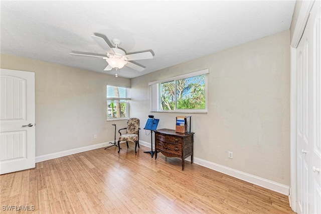 sitting room featuring ceiling fan and light wood-type flooring