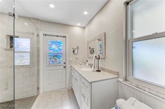 bathroom featuring vanity and a shower with shower door