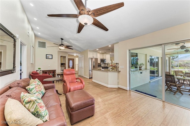 living room featuring light hardwood / wood-style flooring and high vaulted ceiling