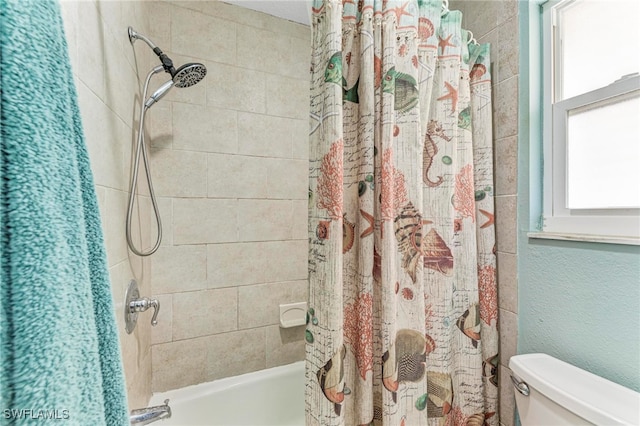 bathroom with toilet and shower / bath combo with shower curtain