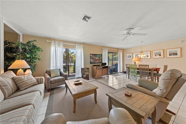 tiled living room featuring ceiling fan