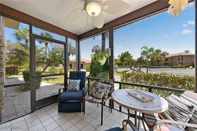 sunroom / solarium featuring ceiling fan