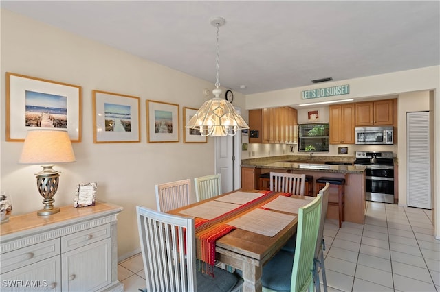 dining space featuring light tile patterned floors