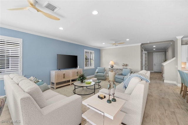 living room featuring light hardwood / wood-style floors and ornamental molding