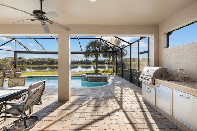 view of patio featuring glass enclosure, area for grilling, and a water view