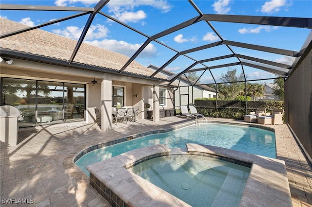 view of swimming pool with a lanai, ceiling fan, a patio area, and an in ground hot tub