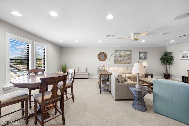 living room featuring light carpet and ceiling fan