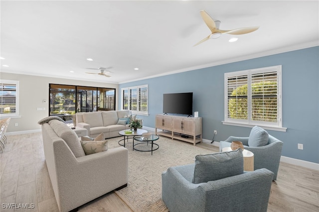 living room with crown molding, ceiling fan, and light wood-type flooring