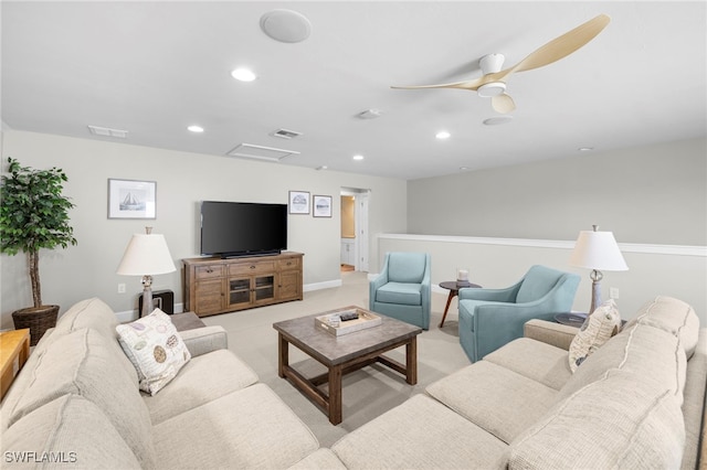 carpeted living room with ceiling fan