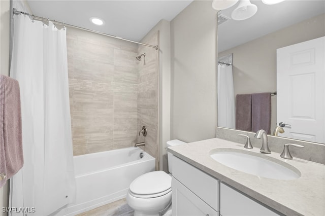 full bathroom featuring vanity, shower / bath combination with curtain, and toilet