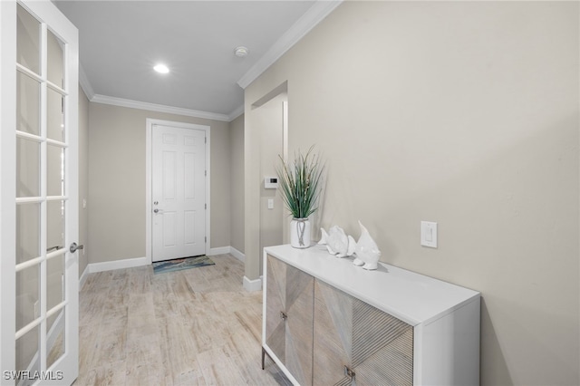 foyer entrance featuring light hardwood / wood-style flooring and ornamental molding