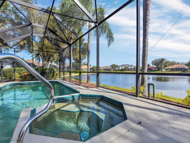 view of pool with a lanai, a water view, and an in ground hot tub