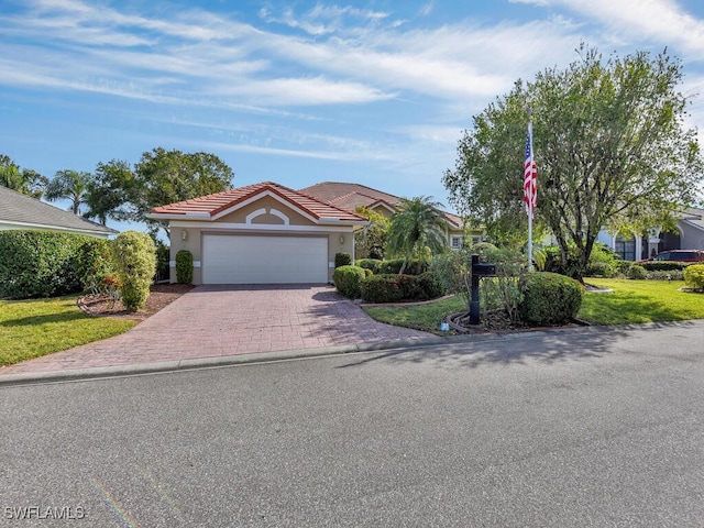 view of front of house featuring a front lawn and a garage