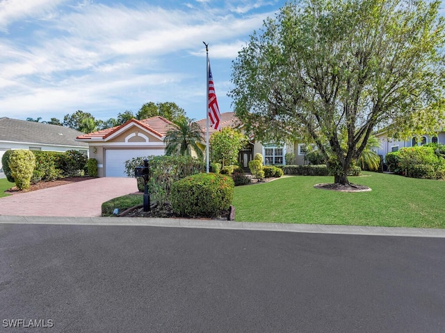 view of front of home featuring a front yard and a garage