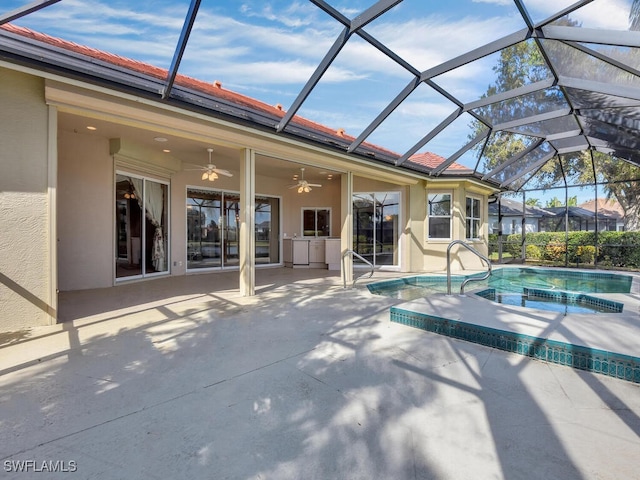 view of pool featuring ceiling fan, a patio area, a lanai, and an in ground hot tub