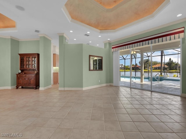 tiled empty room featuring ceiling fan, crown molding, and a tray ceiling