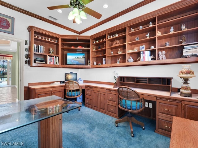 office space featuring built in desk, light colored carpet, and crown molding