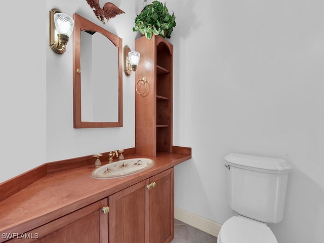 bathroom featuring tile patterned flooring, vanity, and toilet