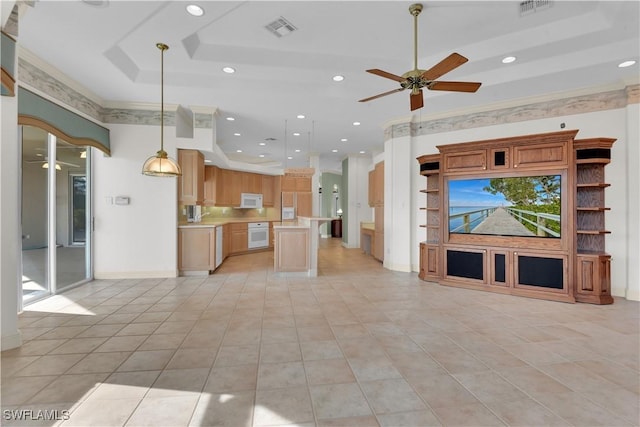 kitchen with white appliances, a raised ceiling, ceiling fan, a center island, and hanging light fixtures