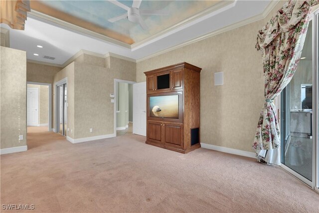 unfurnished living room with carpet, ceiling fan, and crown molding