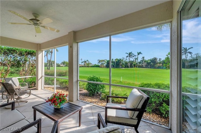 sunroom featuring ceiling fan