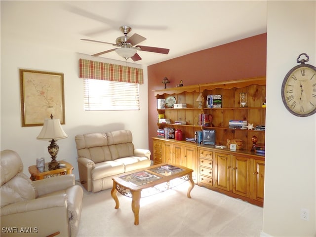 carpeted living room with ceiling fan