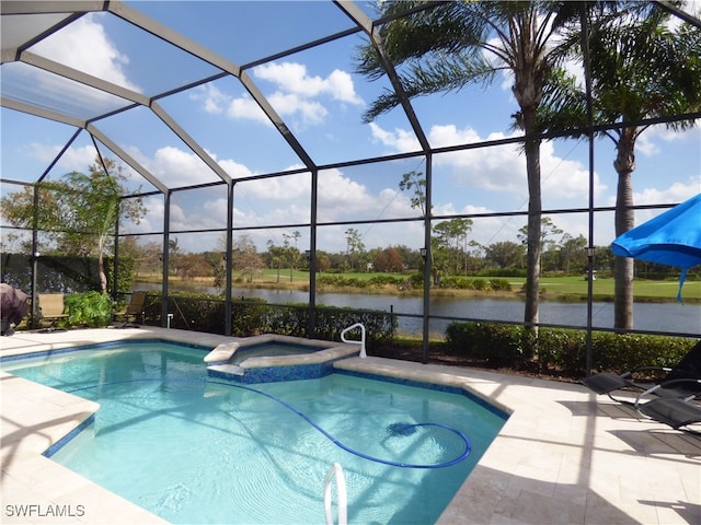 view of pool with a patio, a lanai, an in ground hot tub, and a water view