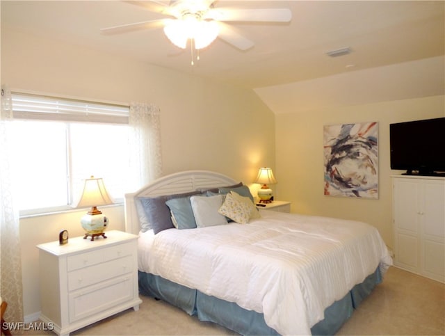 carpeted bedroom featuring vaulted ceiling and ceiling fan