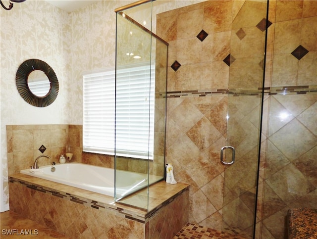 bathroom featuring separate shower and tub