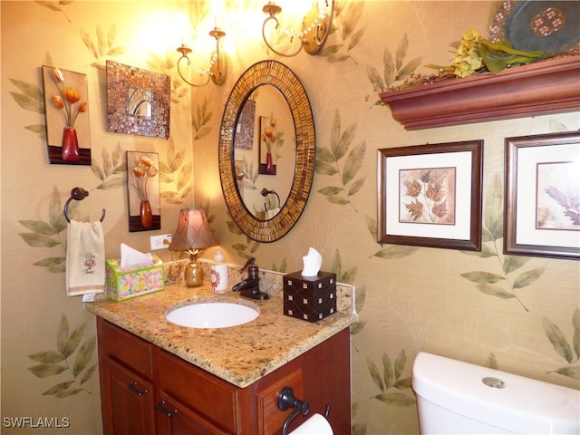 bathroom featuring vanity and toilet