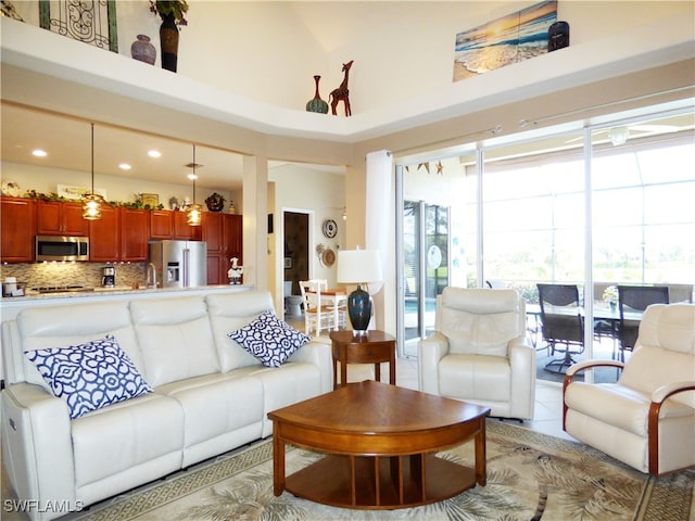 living room featuring high vaulted ceiling and tile patterned flooring