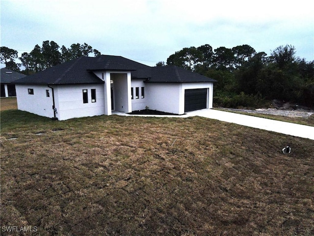 view of front of property with a garage and a front yard