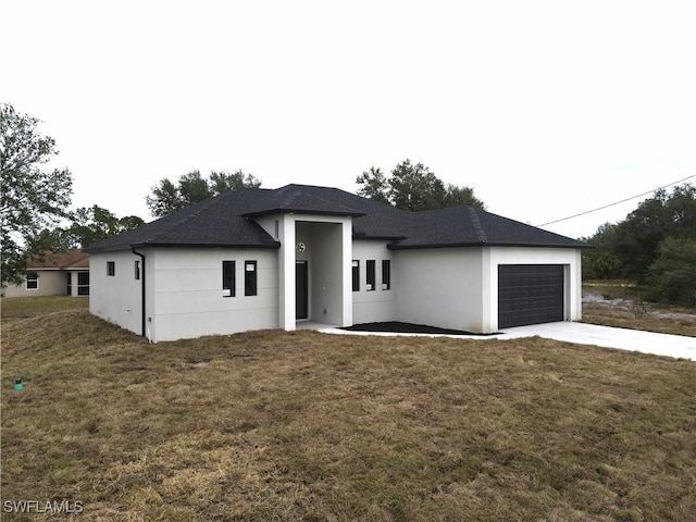 prairie-style house with a front yard and a garage