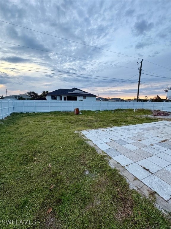 yard at dusk with a patio