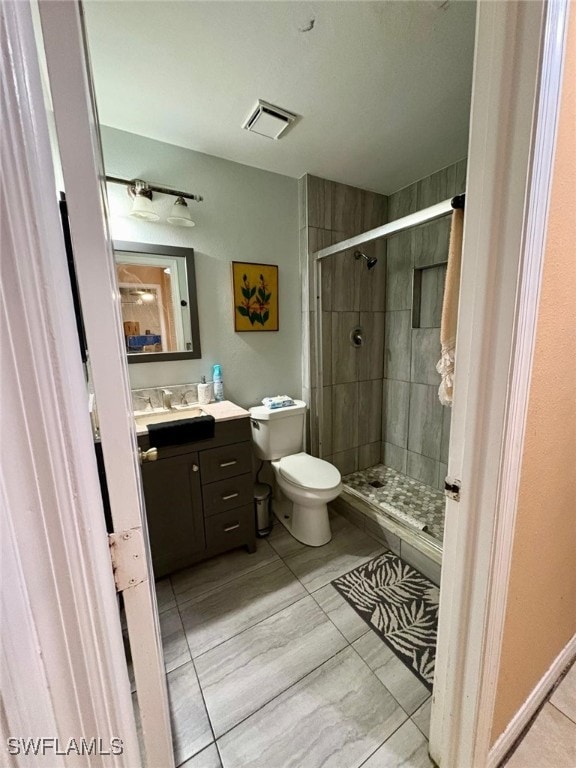 bathroom with vanity, toilet, and an enclosed shower