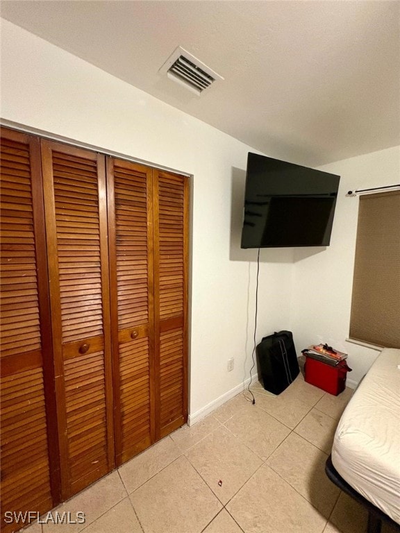 interior space featuring a closet and light tile patterned floors