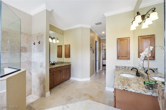 bathroom featuring tiled shower, vanity, a chandelier, and ornamental molding