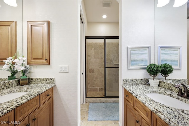 bathroom featuring tile patterned floors, vanity, and walk in shower