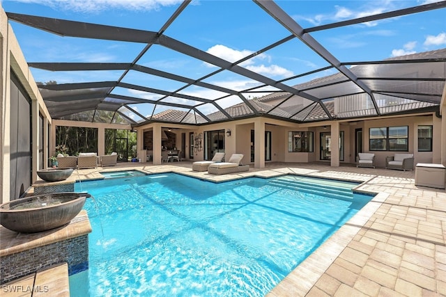 view of swimming pool featuring outdoor lounge area, an in ground hot tub, a patio, and glass enclosure