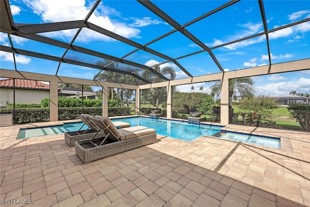 view of swimming pool featuring a lanai, an in ground hot tub, pool water feature, and a patio