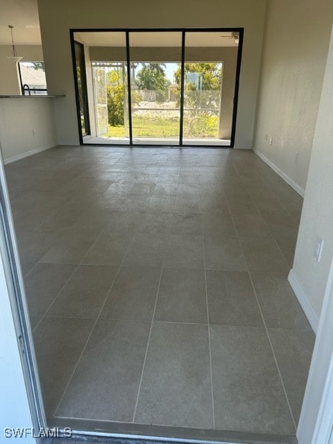 tiled empty room with a healthy amount of sunlight