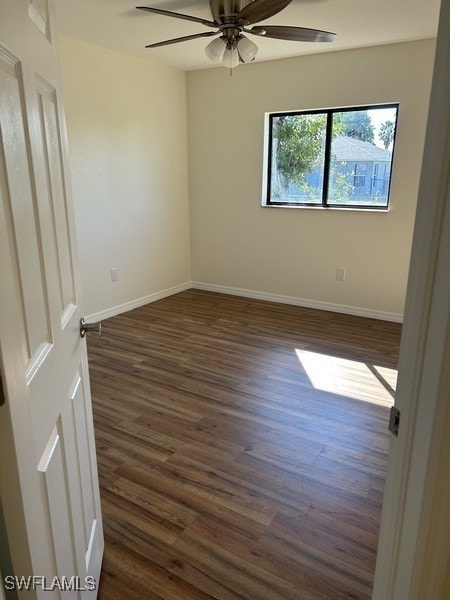 unfurnished room with ceiling fan and dark hardwood / wood-style flooring