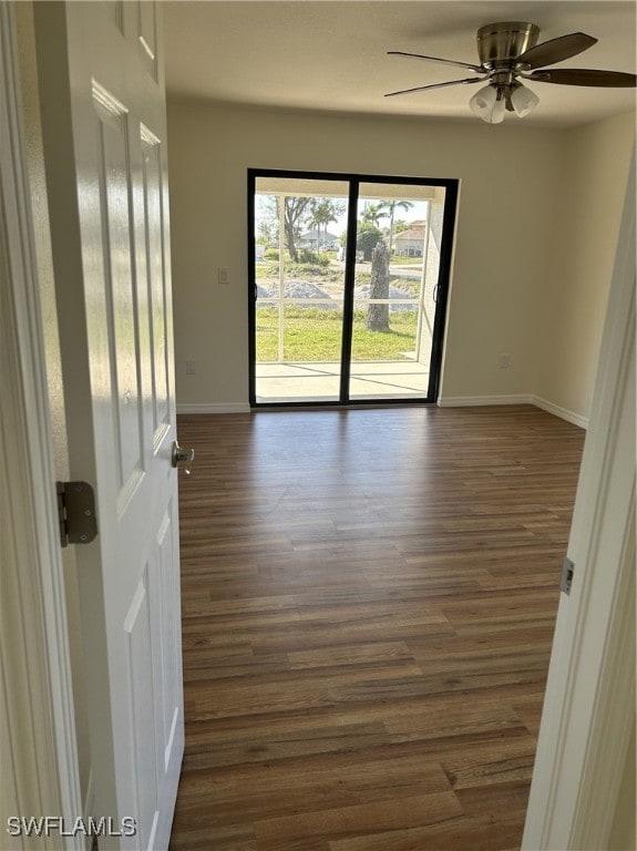 spare room featuring ceiling fan and dark hardwood / wood-style flooring