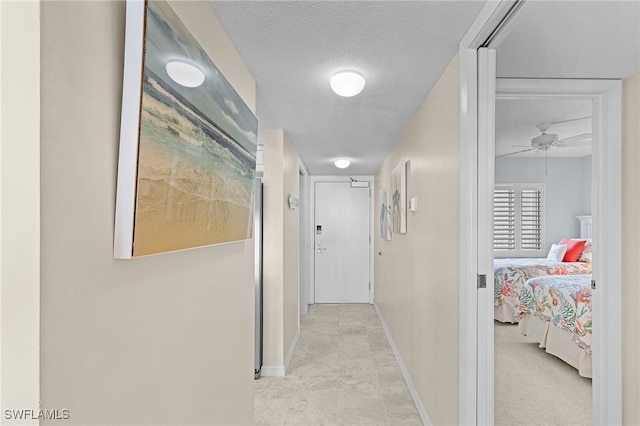 hallway with a textured ceiling